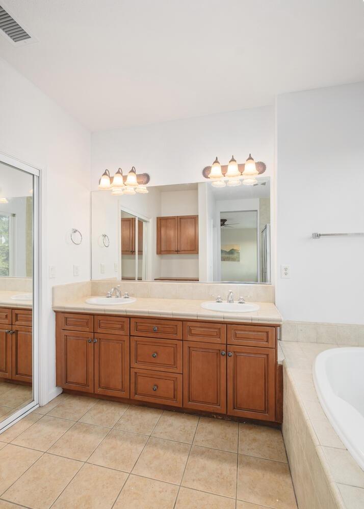 3331 Serena Avenue Clovis, CA 93619 - Photo 28 of 41 a spacious bathroom with a tub sink and mirror