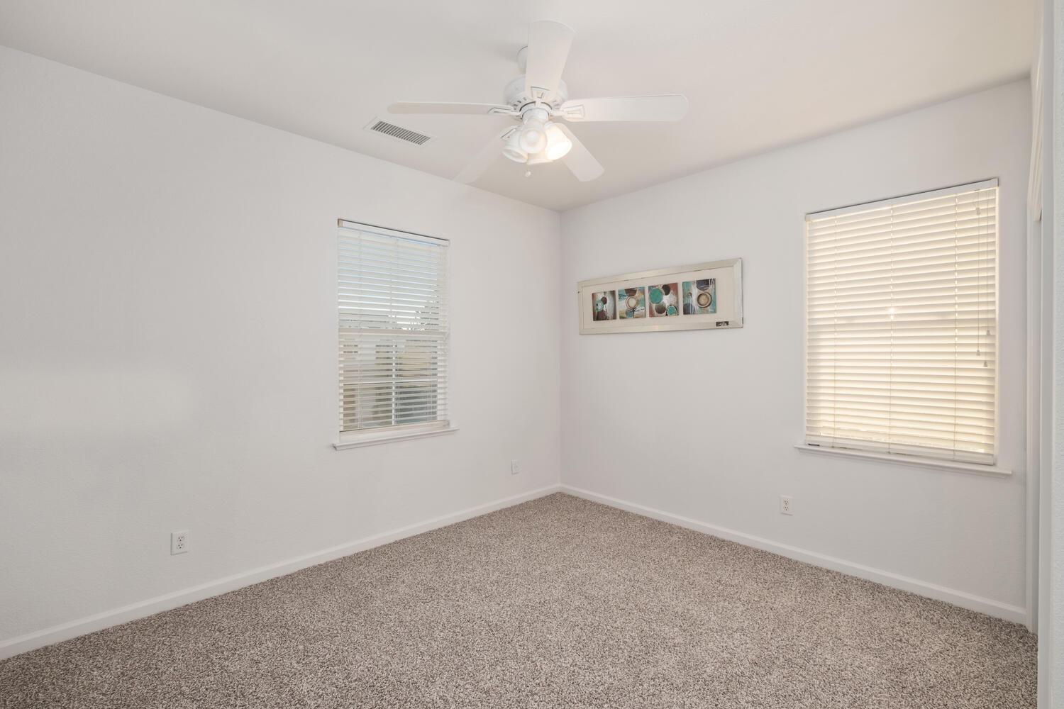 3331 Serena Avenue Clovis, CA 93619 - Photo 30 of 41 an empty room with windows and fan