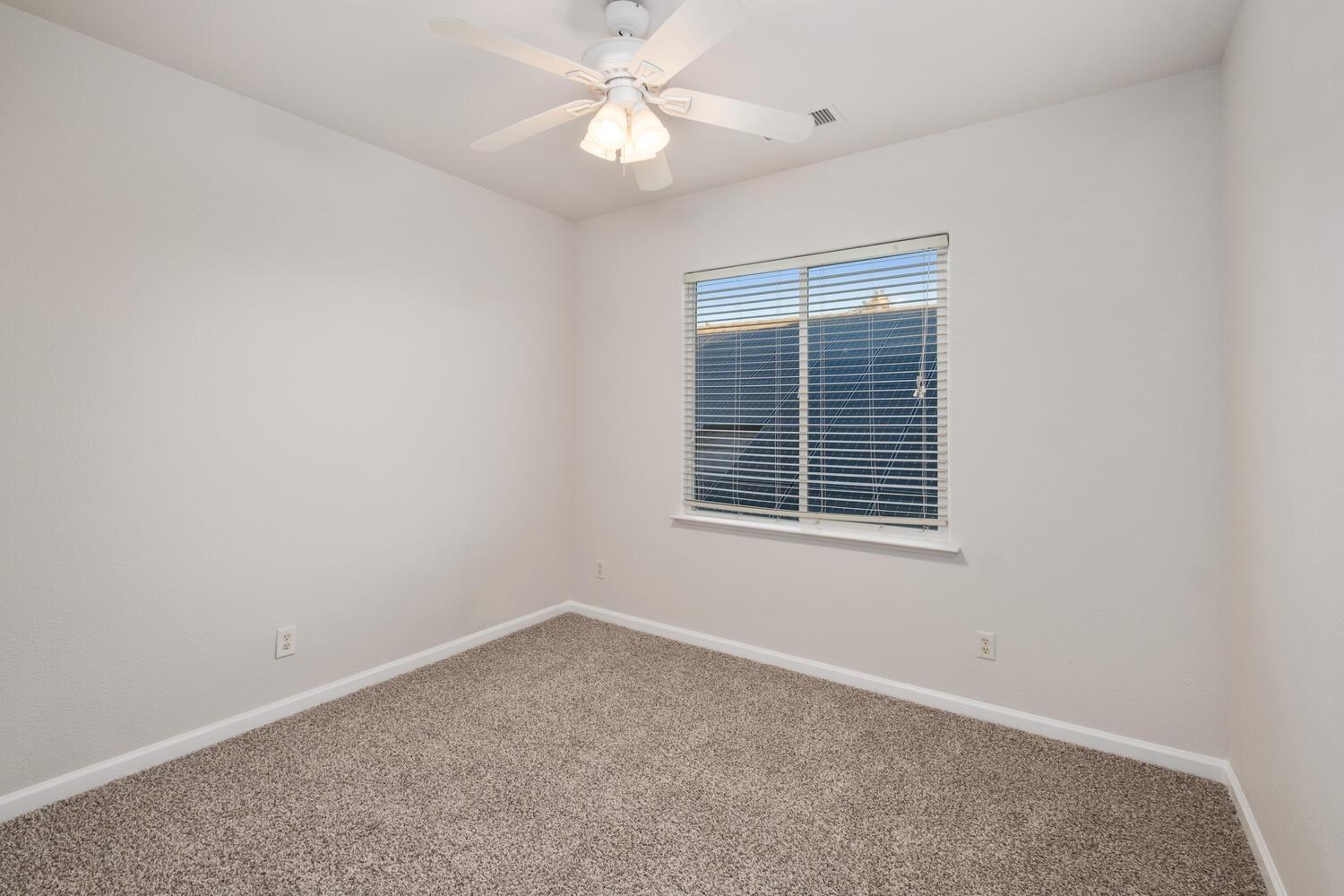 3331 Serena Avenue Clovis, CA 93619 - Photo 33 of 41 an empty room with a window and a fan