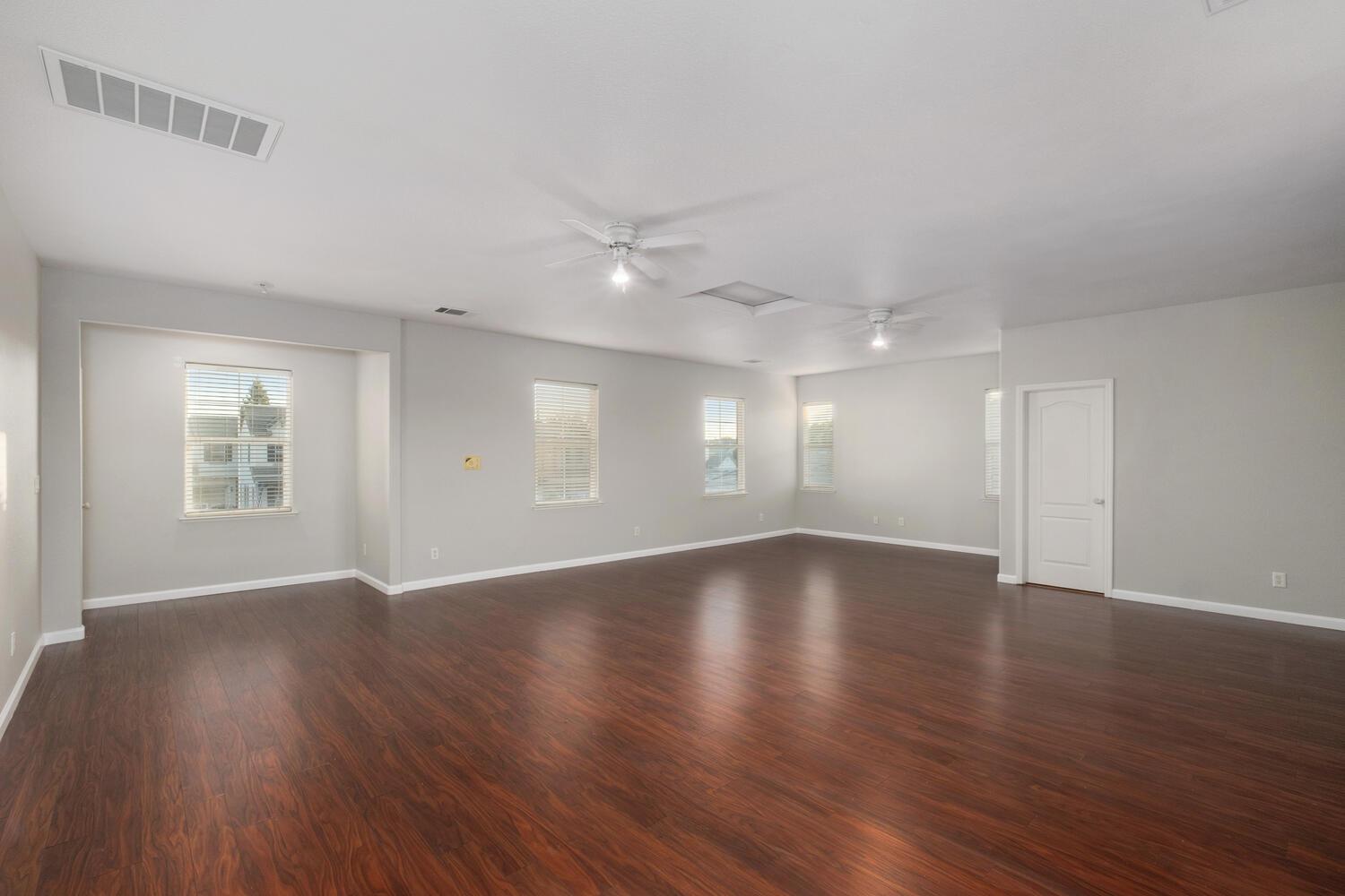 3331 Serena Avenue Clovis, CA 93619 - Photo 35 of 41 an empty room with wooden floor and windows