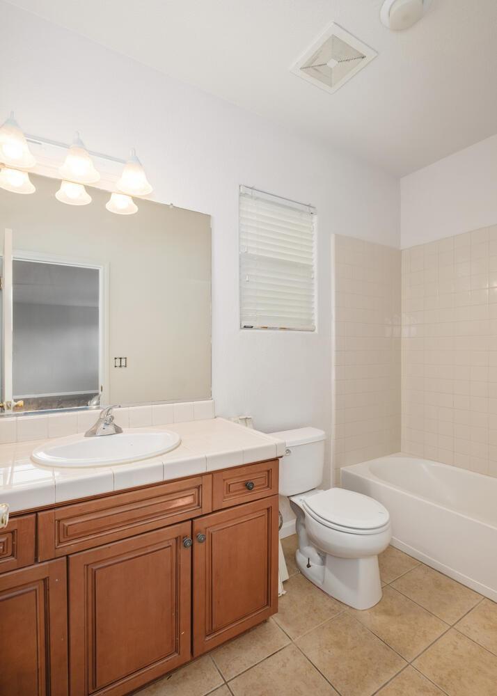 3331 Serena Avenue Clovis, CA 93619 - Photo 36 of 41 a spacious bathroom with a sink a toilet and a mirror