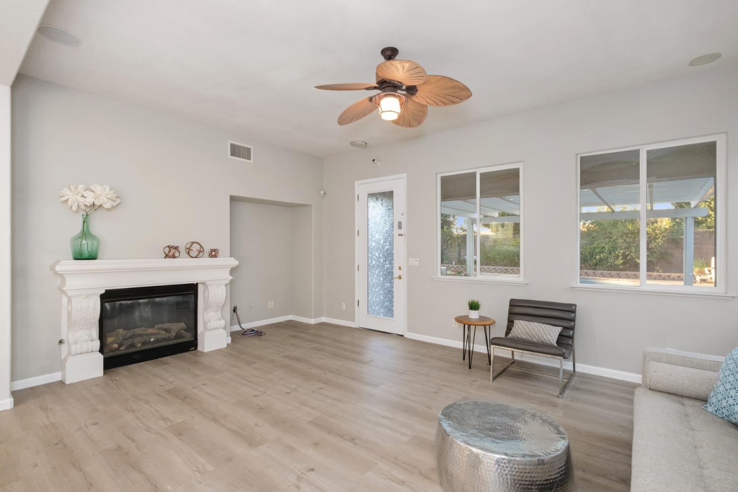 3331 Serena Avenue Clovis, CA 93619 - Photo 7 of 41 a living room with furniture a fireplace and a window