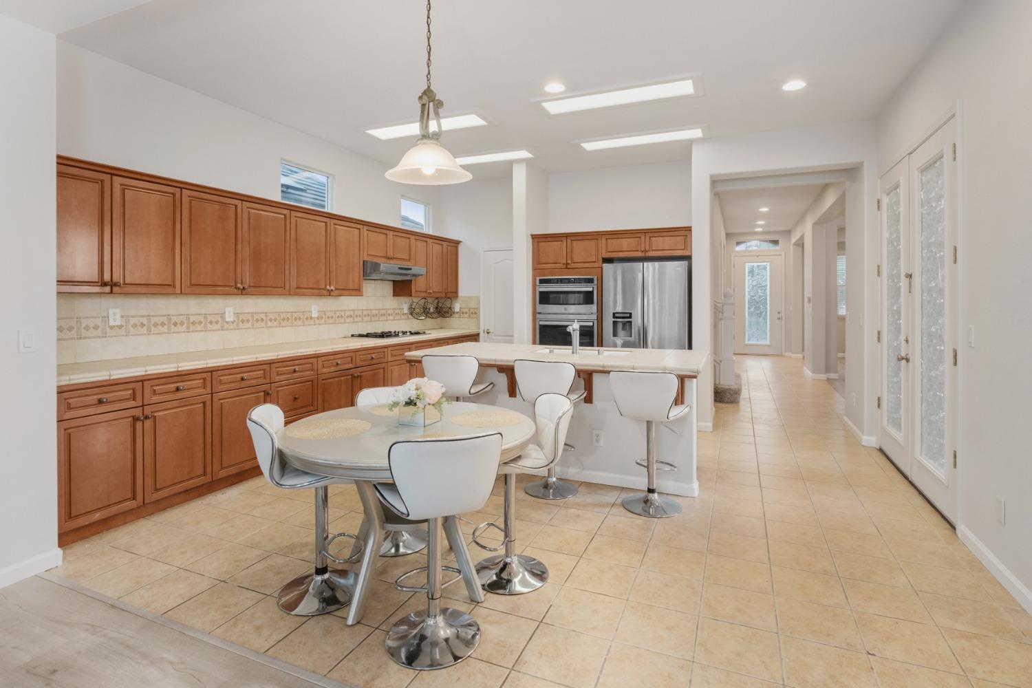 3331 Serena Avenue Clovis, CA 93619 - Photo 8 of 41 a living room with furniture a dining table and kitchen view