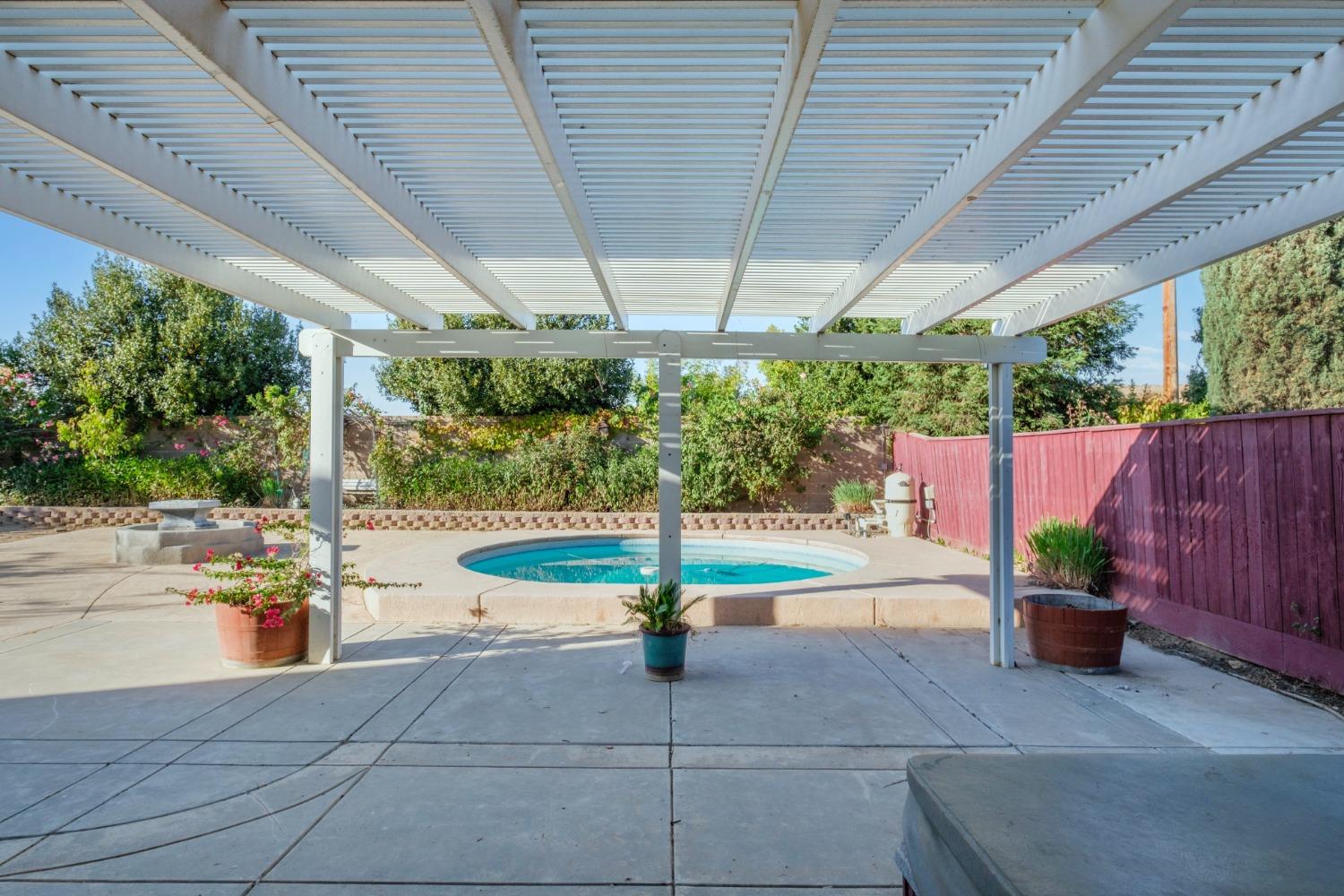 3331 Serena Avenue Clovis, CA 93619 - Photo 9 of 41 a view of a swimming pool with a patio