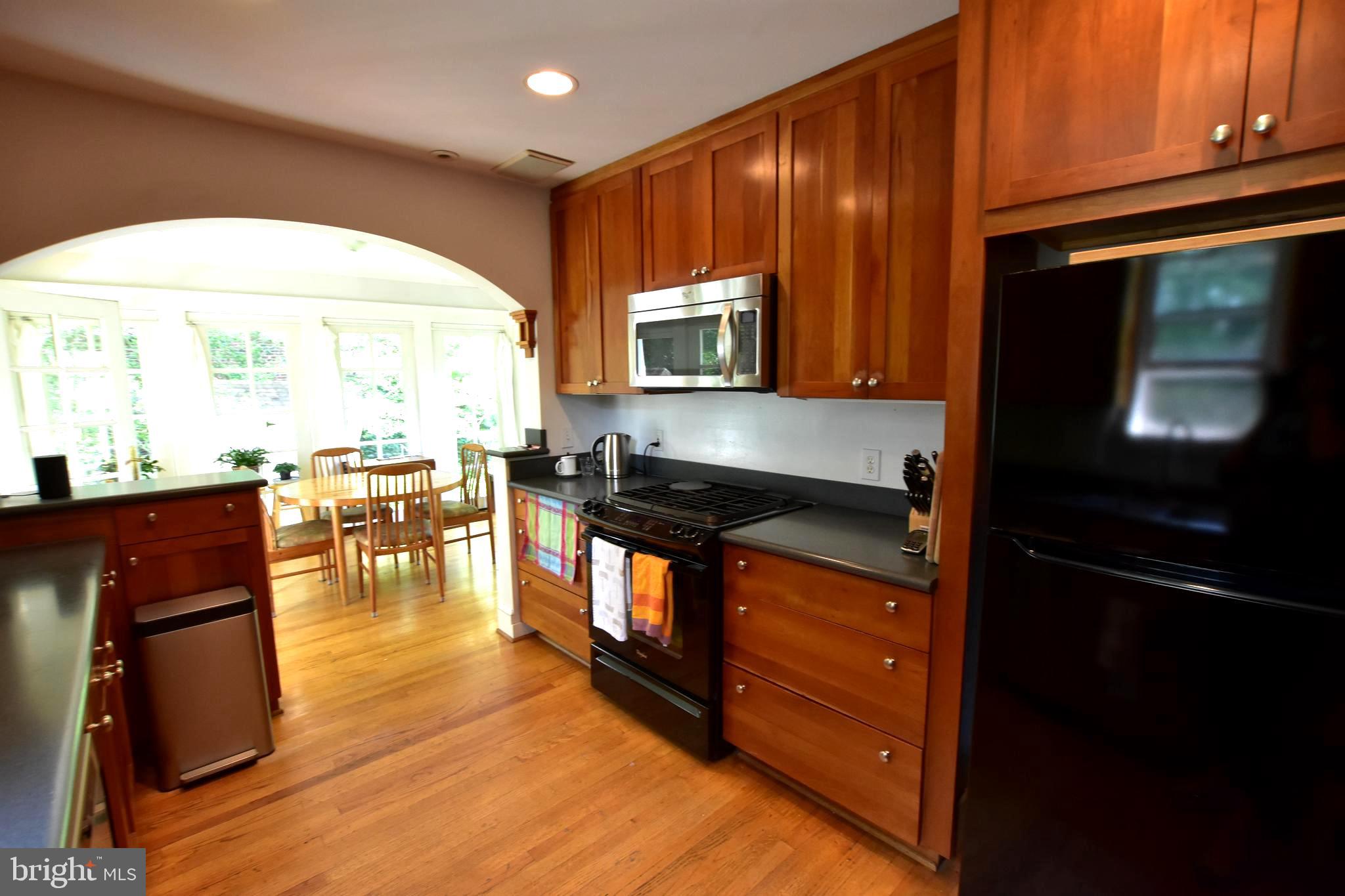 1300 Noyes Drive Silver Spring, MD 20910 - Photo 11 of 30 a kitchen with granite countertop wooden cabinets and a stove top oven