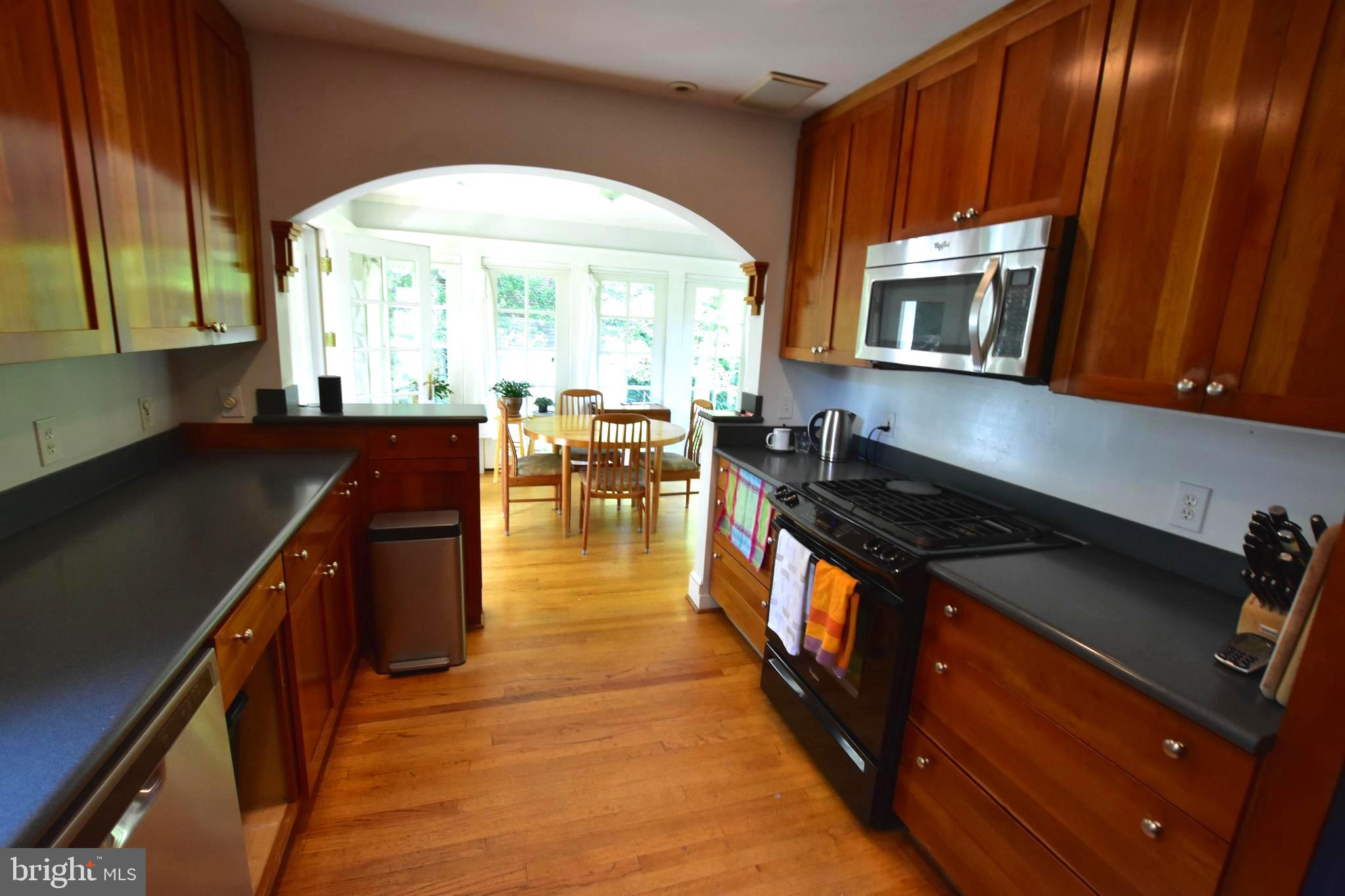 1300 Noyes Drive Silver Spring, MD 20910 - Photo 10 of 30 a kitchen with stainless steel appliances granite countertop a stove a sink and a microwave