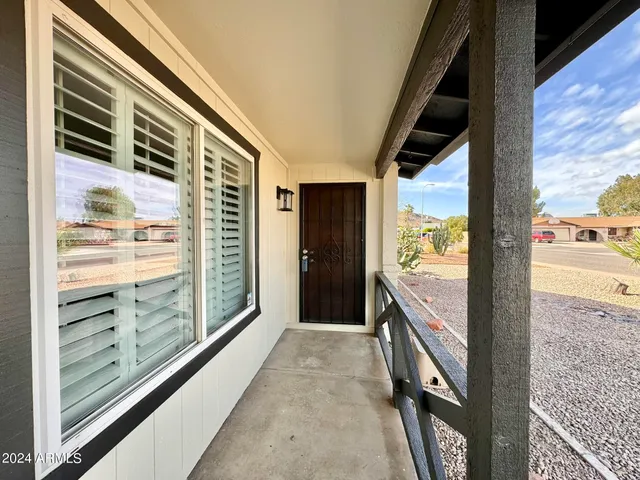 a view of a hallway with wooden floor and a large window