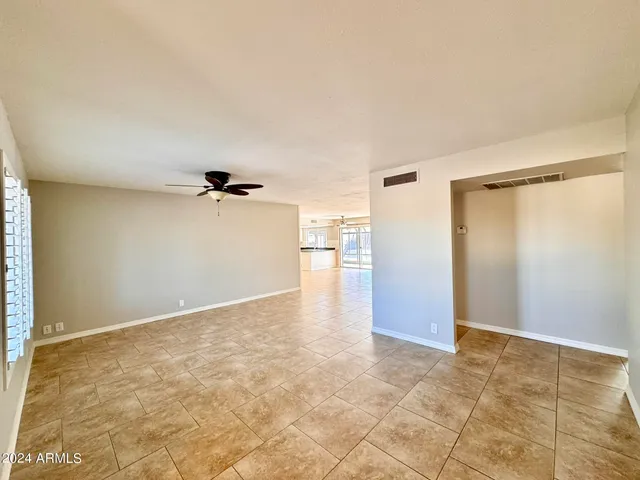 a view of a big room with closet and windows