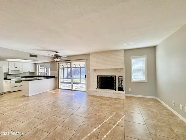 a view of kitchen with microwave and cabinets