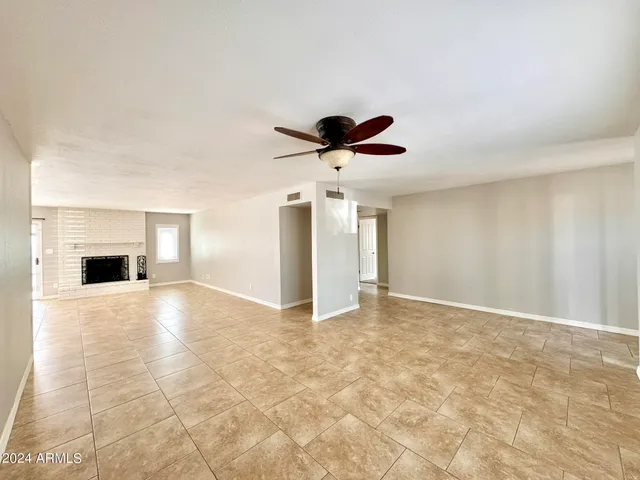 a view of empty room with cabinet and ceiling fan