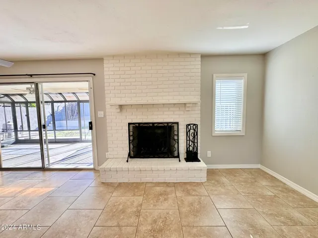 a view of a livingroom with an empty space and a fireplace