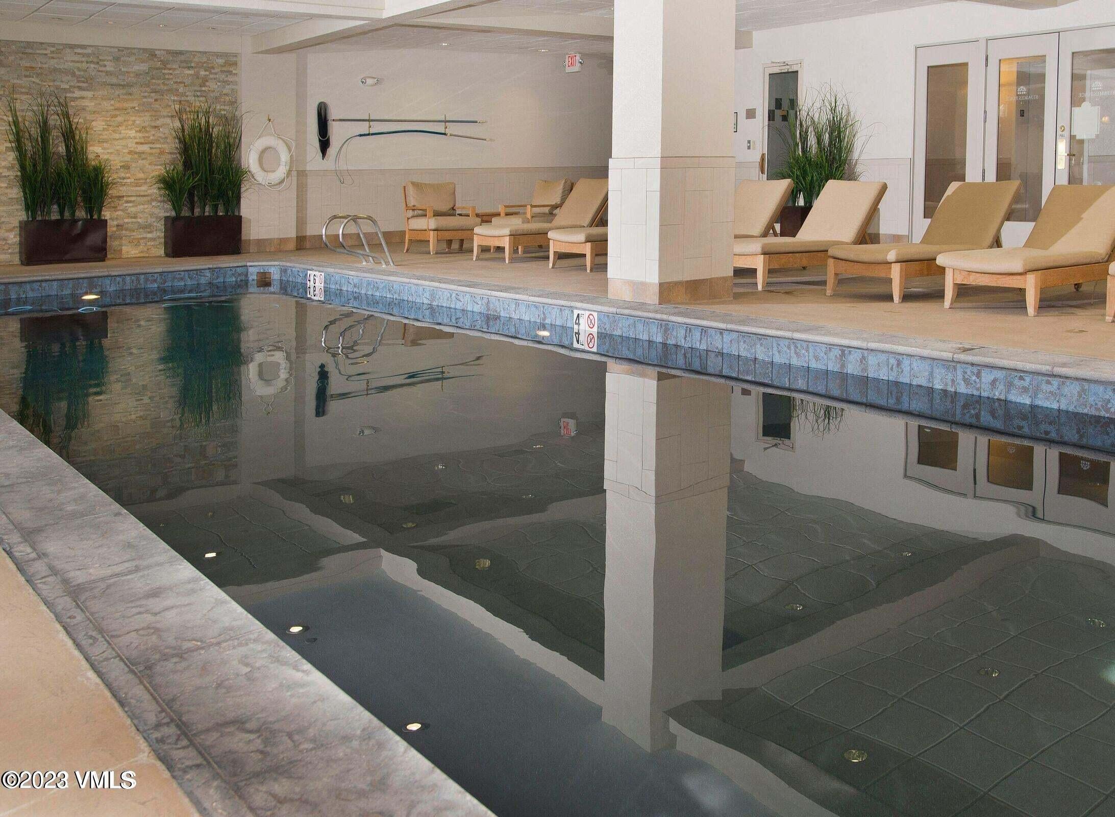 210 Offerson Road, Unit 109WEEK 11 Beaver Creek, CO 81620 - Photo 16 of 25 a kitchen with granite countertop a sink and white cabinets