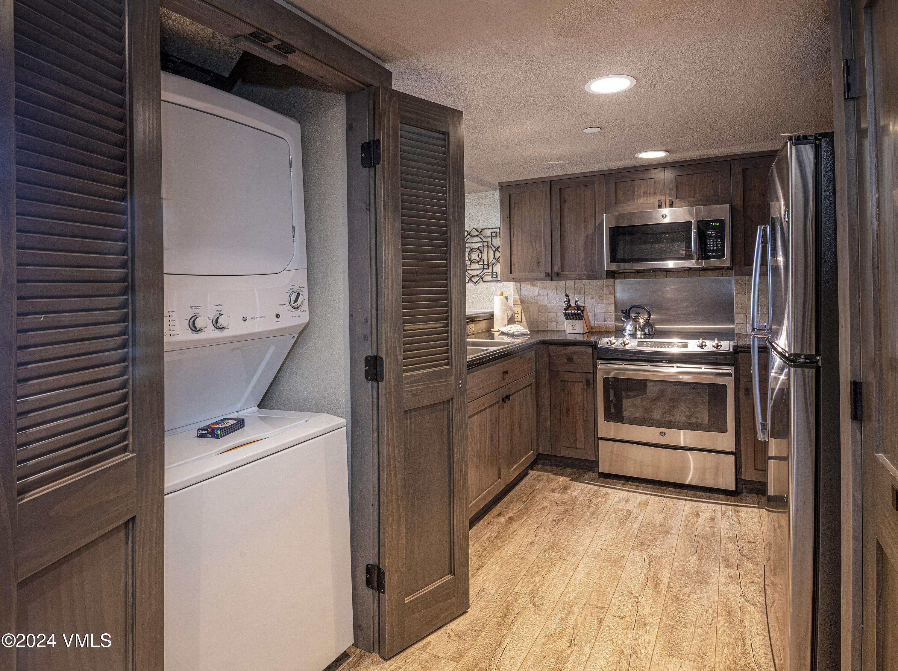 210 Offerson Road, Unit 109WEEK 11 Beaver Creek, CO 81620 - Photo 7 of 25 a kitchen with a sink stainless steel appliances and cabinets