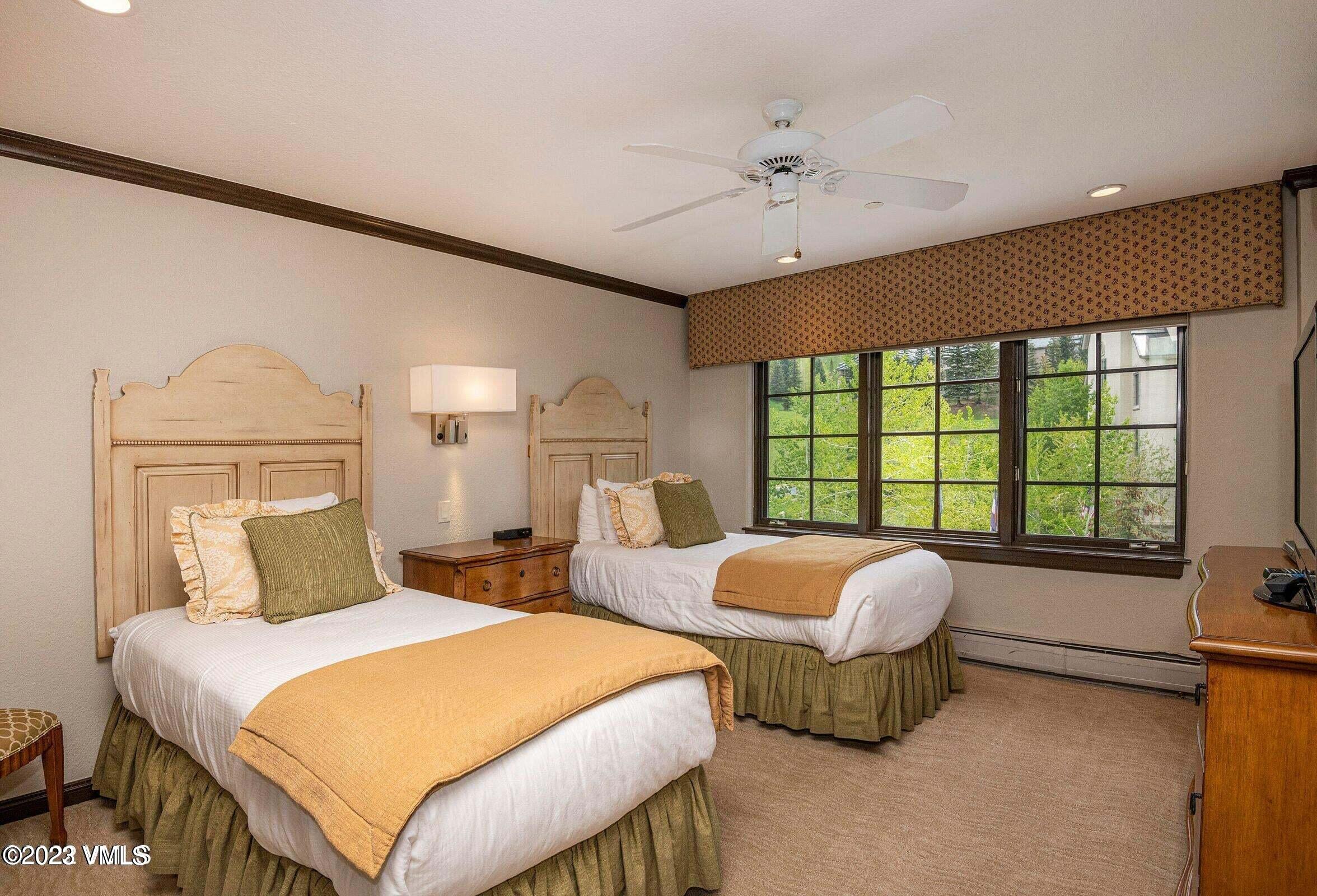 210 Offerson Road, Unit 109WEEK 11 Beaver Creek, CO 81620 - Photo 10 of 25 a bedroom with two beds and a large window