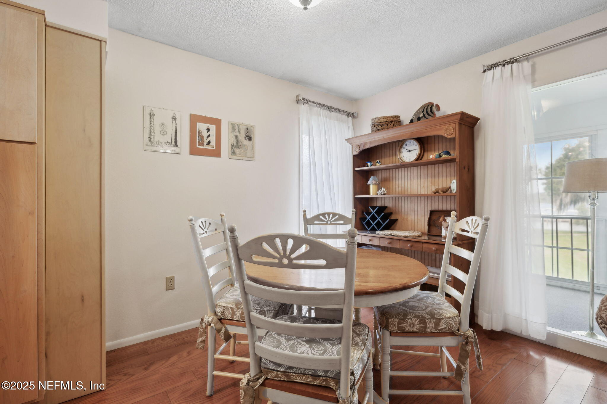 210 River Bend Court, Unit B Welaka, FL 32193 - Photo 10 of 41 a view of a dining room with furniture and wooden floor