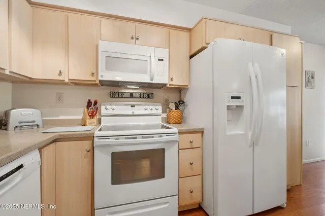 a kitchen with cabinets appliances a sink and a counter top space