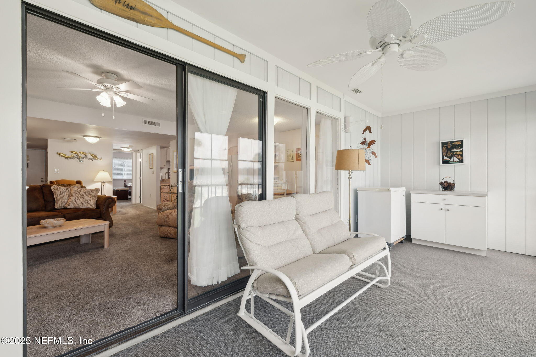 210 River Bend Court, Unit B Welaka, FL 32193 - Photo 19 of 41 a living room with furniture and a large window