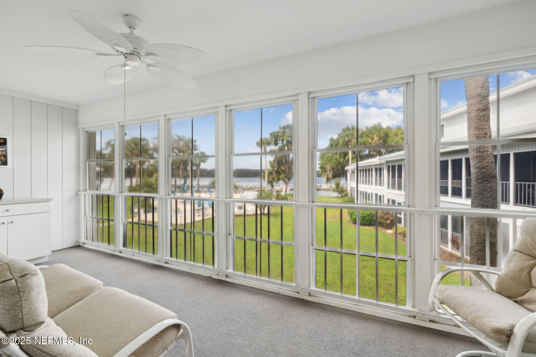 210 River Bend Court, Unit B Welaka, FL 32193 - Photo 21 of 41 a living room with furniture and a large window