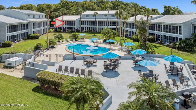 a view of a swimming pool with a patio and plants