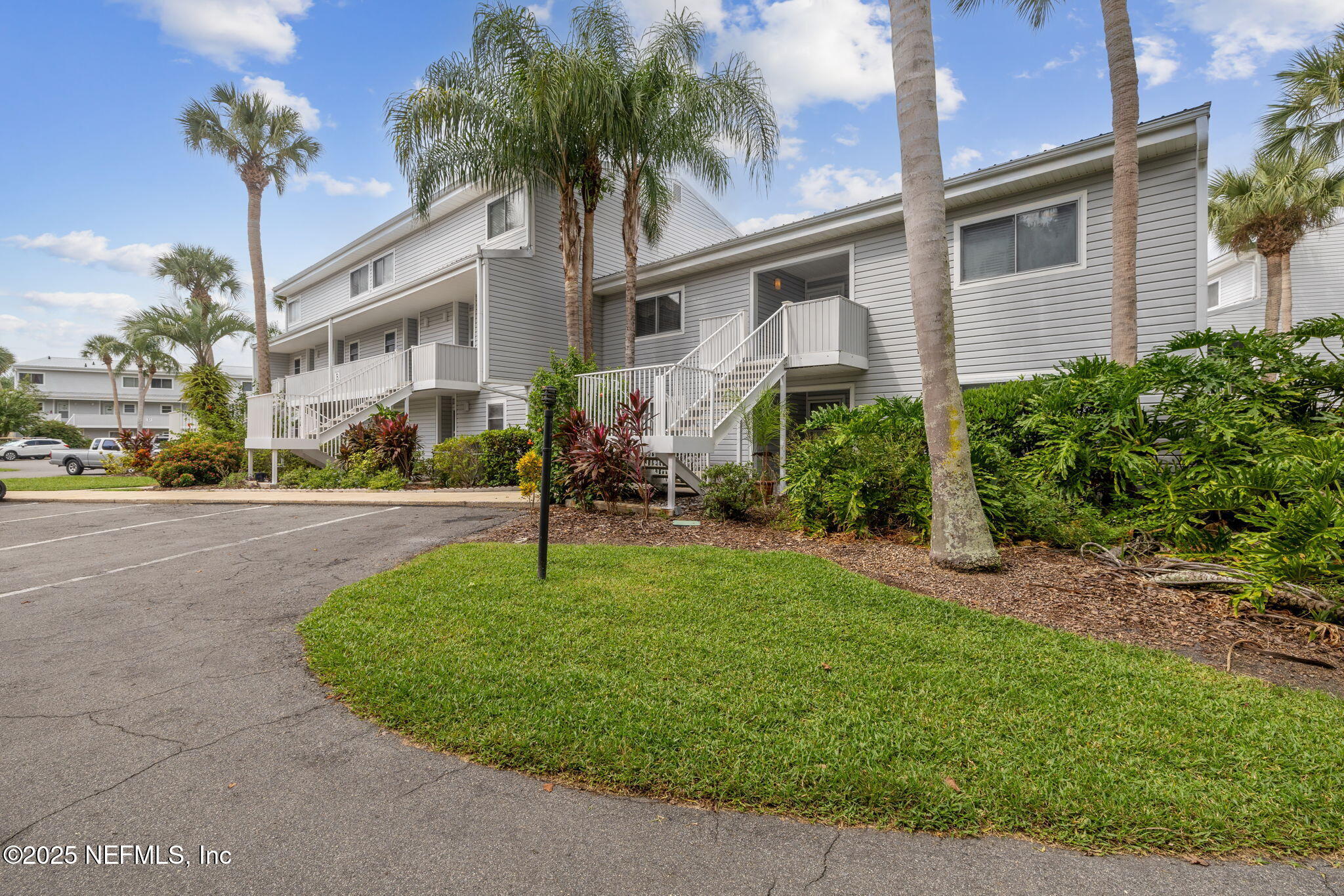 210 River Bend Court, Unit B Welaka, FL 32193 - Photo 36 of 41 a front view of a house with garden and porch