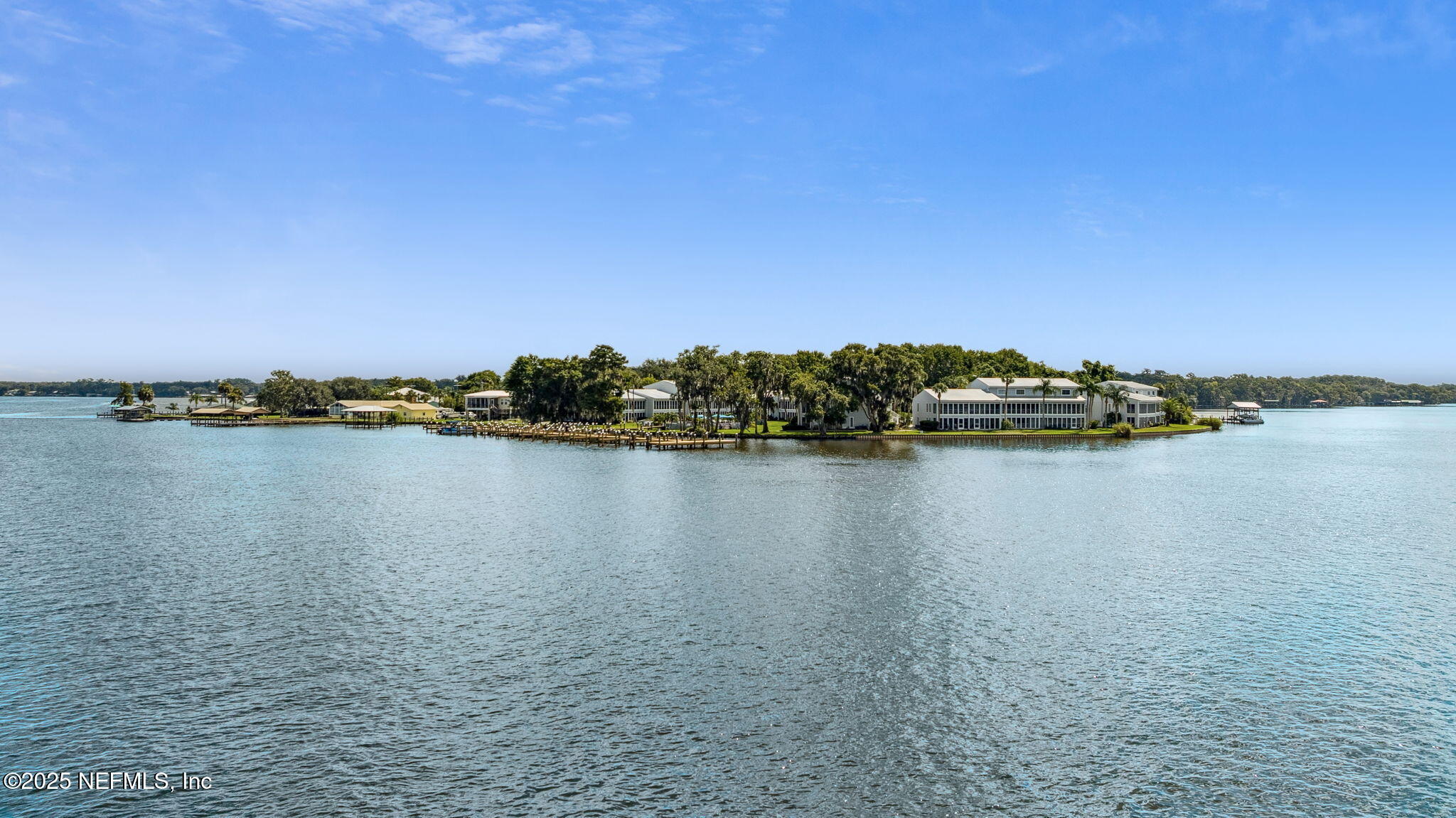 210 River Bend Court, Unit B Welaka, FL 32193 - Photo 39 of 41 a view of a lake with houses in the background