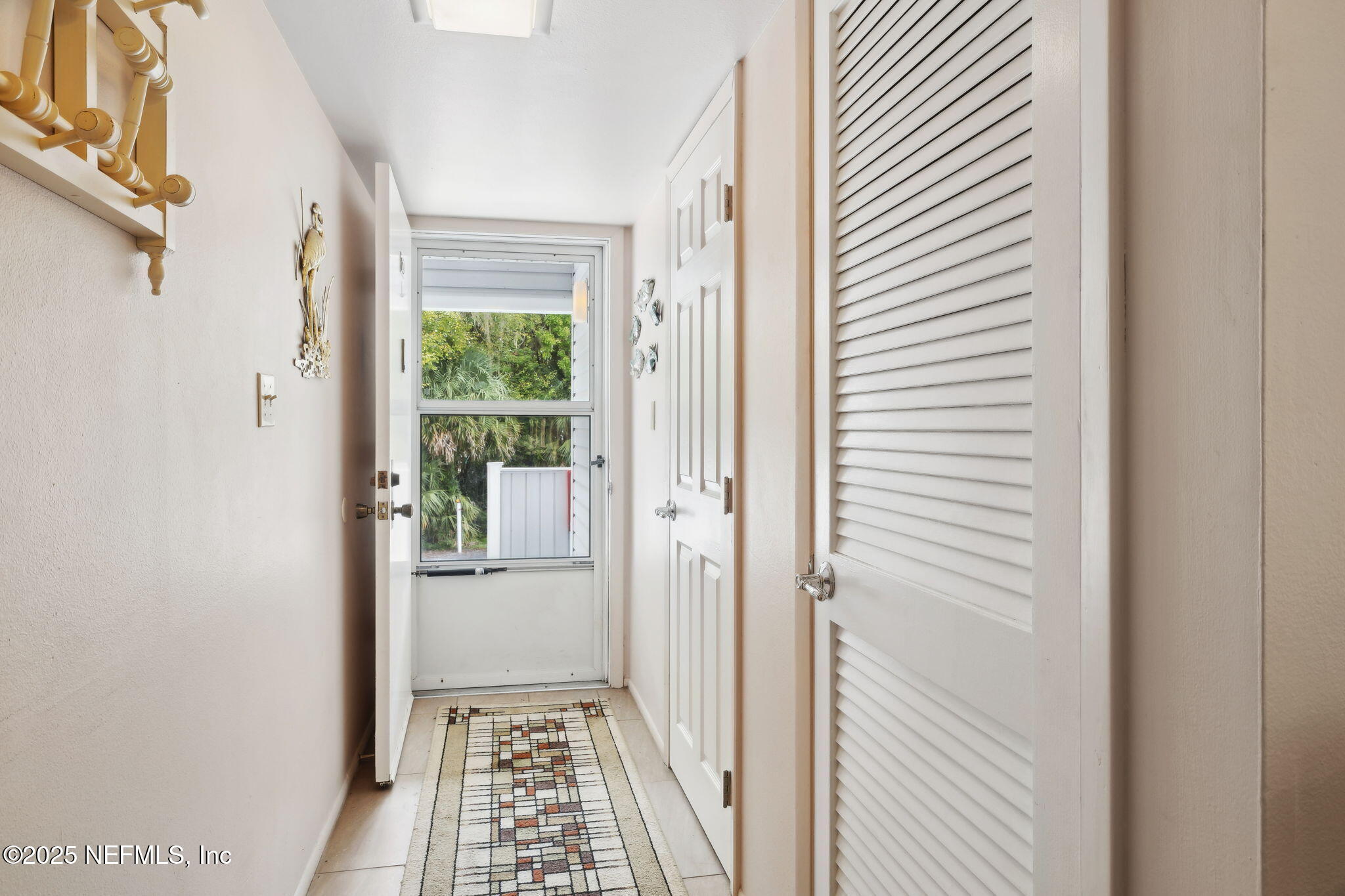 210 River Bend Court, Unit B Welaka, FL 32193 - Photo 4 of 41 a view of a hallway with wooden floor and a dining room