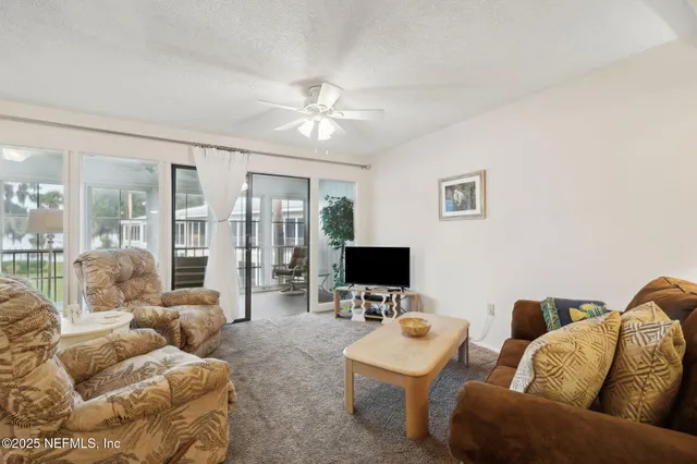 a bedroom with furniture and a flat screen tv