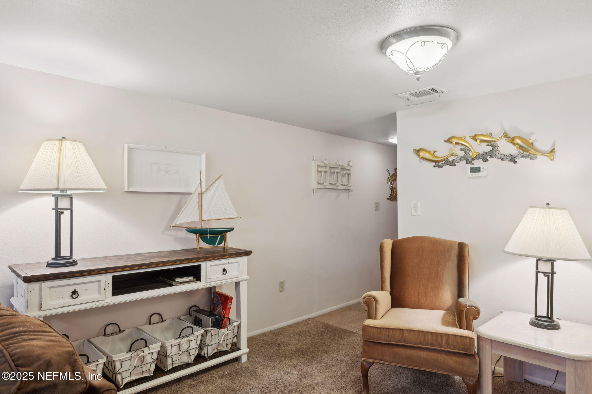 210 River Bend Court, Unit B Welaka, FL 32193 - Photo 7 of 41 a living room with a bed and a table