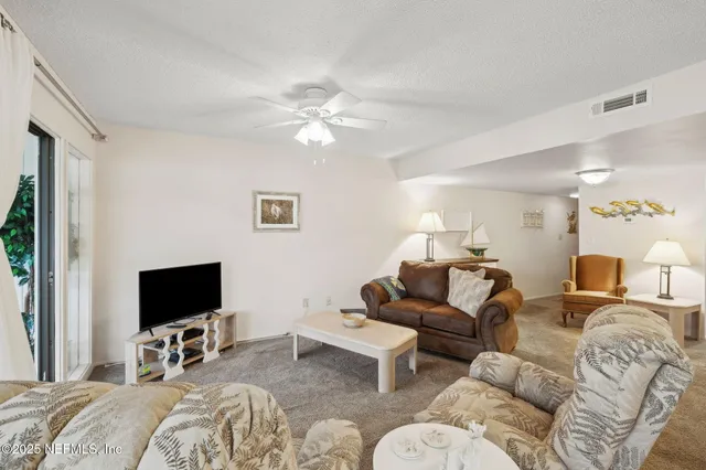 a living room with a bed and a table