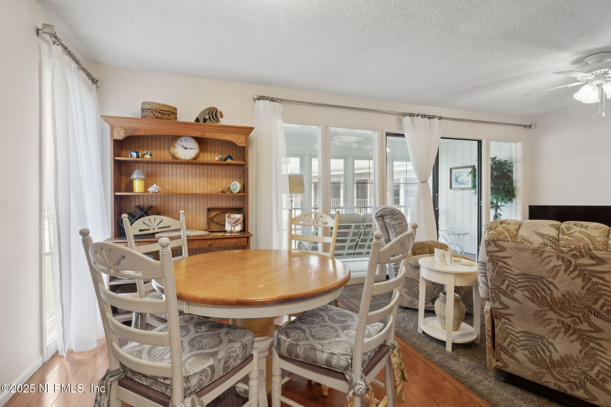 210 River Bend Court, Unit B Welaka, FL 32193 - Photo 9 of 41 a dining room with furniture and wooden floor