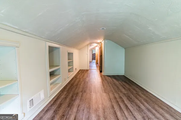 a view of hallway with wooden floor