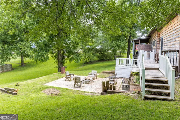 a view of a backyard with sitting area