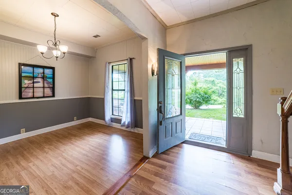 a kitchen with a stove a sink a kitchen island with windows and cabinets