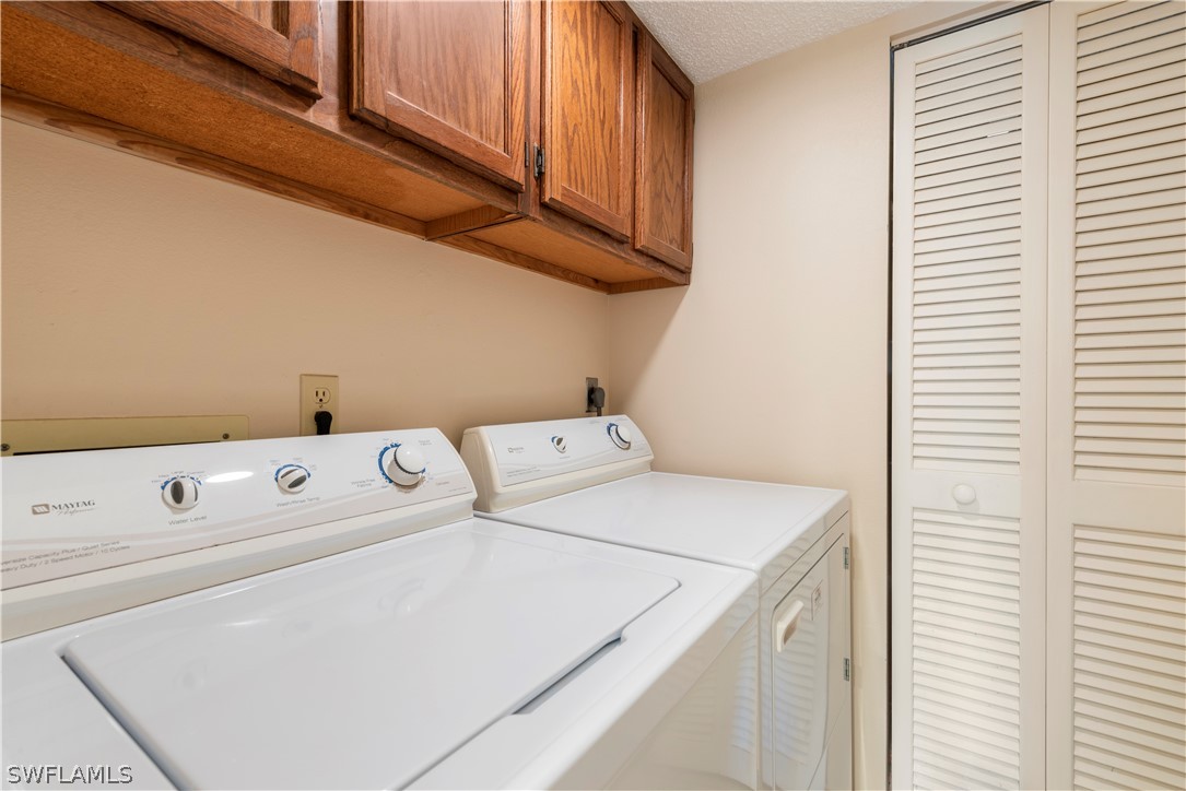 15021 Punta Rassa Road, Unit 201 Fort Myers, FL 33908 - Photo 11 of 29 a utility room with dryer and washer