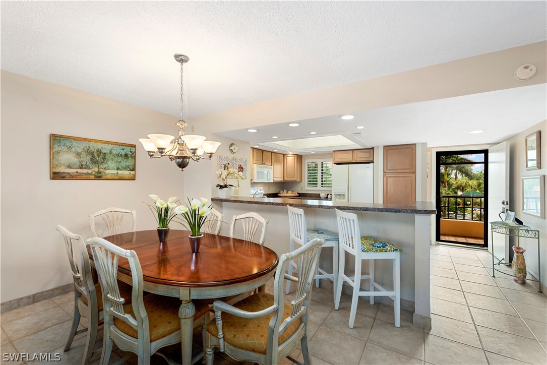 15021 Punta Rassa Road, Unit 201 Fort Myers, FL 33908 - Photo 13 of 29 a dining room with furniture and window