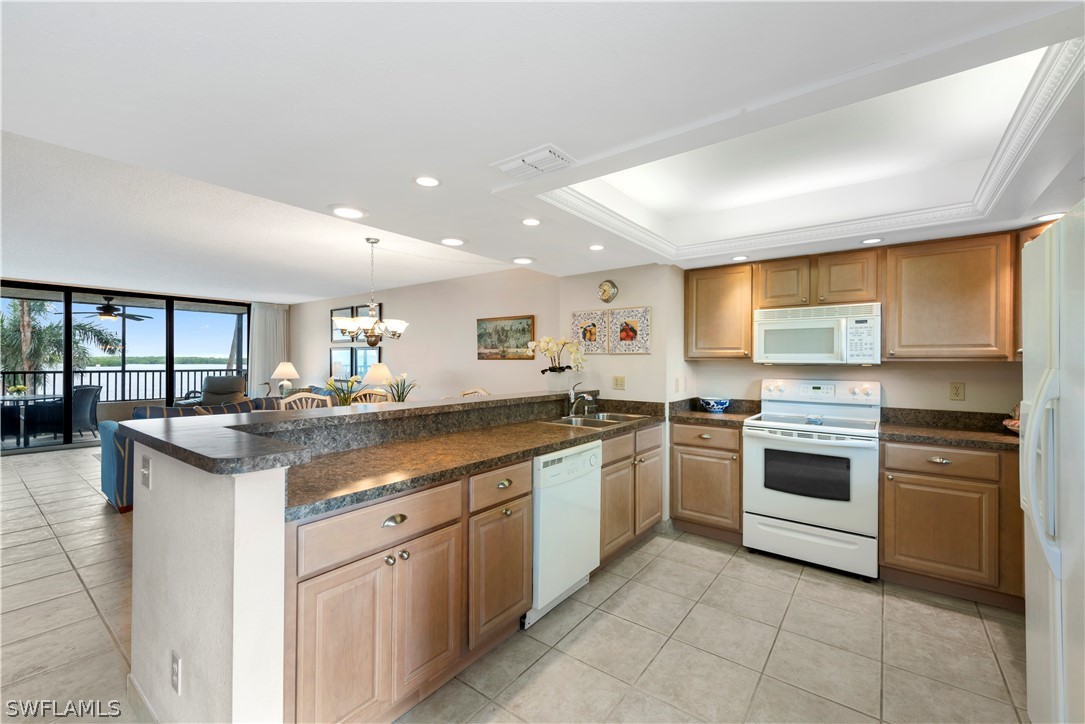 15021 Punta Rassa Road, Unit 201 Fort Myers, FL 33908 - Photo 14 of 29 a kitchen with stainless steel appliances granite countertop a stove and a sink