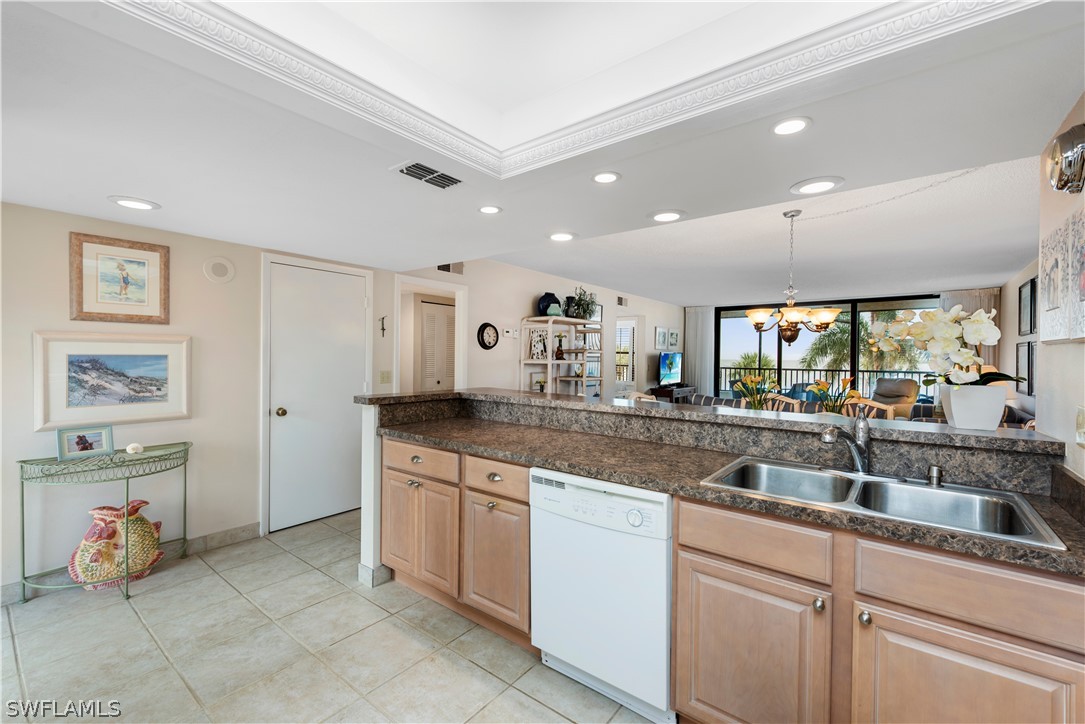 15021 Punta Rassa Road, Unit 201 Fort Myers, FL 33908 - Photo 15 of 29 a kitchen with a sink and cabinets