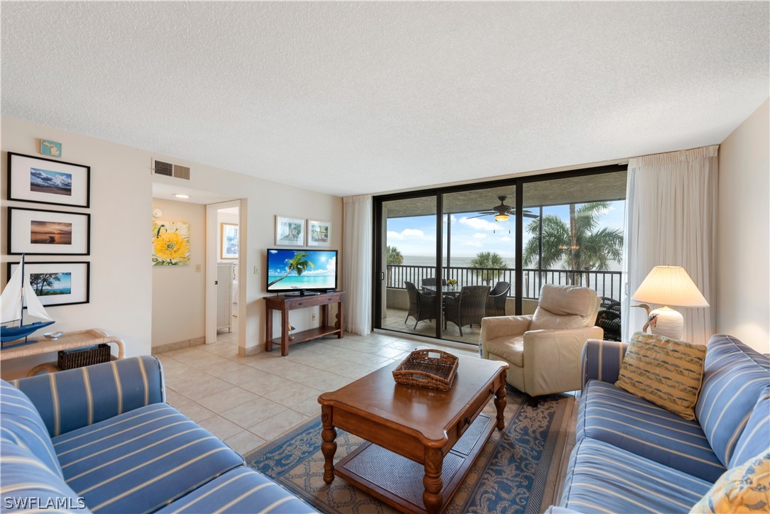 15021 Punta Rassa Road, Unit 201 Fort Myers, FL 33908 - Photo 4 of 29 a living room with furniture and a wooden floor