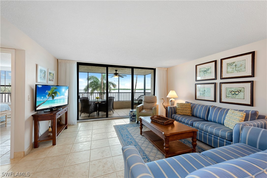 15021 Punta Rassa Road, Unit 201 Fort Myers, FL 33908 - Photo 5 of 29 a living room with furniture and a flat screen tv