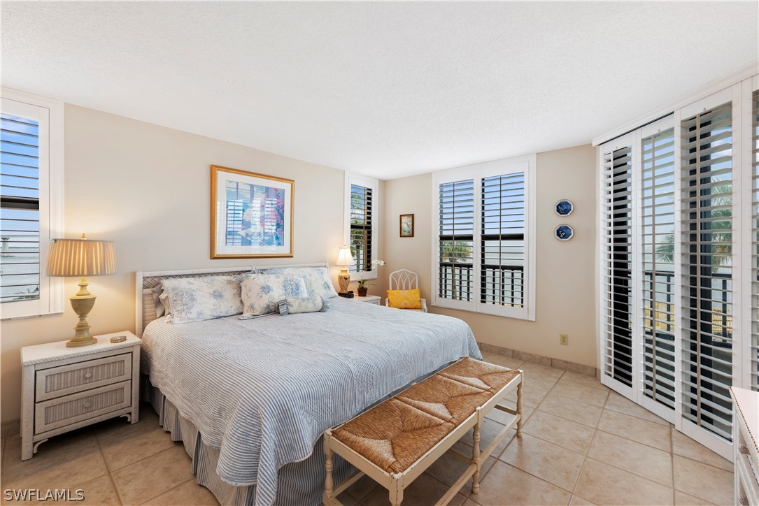 15021 Punta Rassa Road, Unit 201 Fort Myers, FL 33908 - Photo 6 of 29 a bedroom with a bed and a window