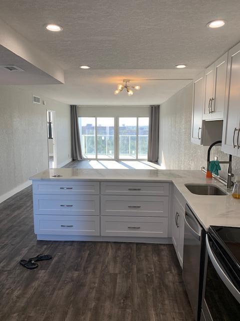 1401 North Riverside Drive, Unit 1205 Pompano Beach, FL 33062 - Photo 12 of 26 a bathroom with a sink and a large mirror