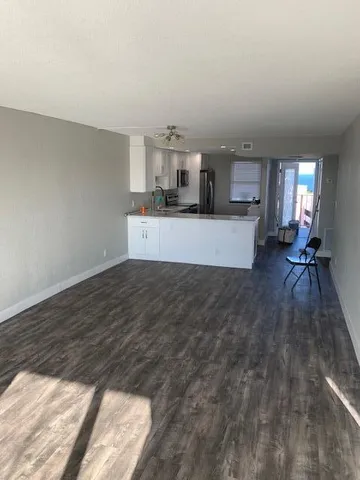 a view of a living room hardwood and a kitchen