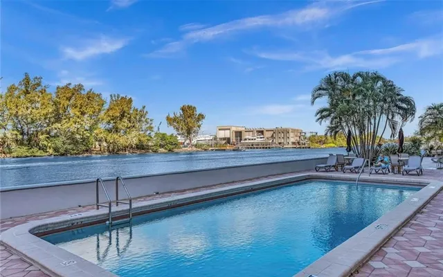 a view of swimming pool with a table and chairs