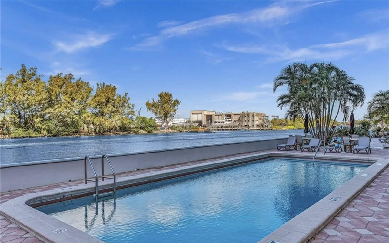 1401 North Riverside Drive, Unit 1205 Pompano Beach, FL 33062 - Photo 2 of 26 a view of swimming pool with a table and chairs