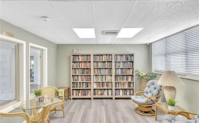 a living room with furniture and a book shelf