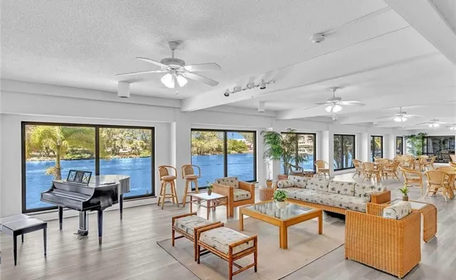 a living room with furniture dining table and a large window