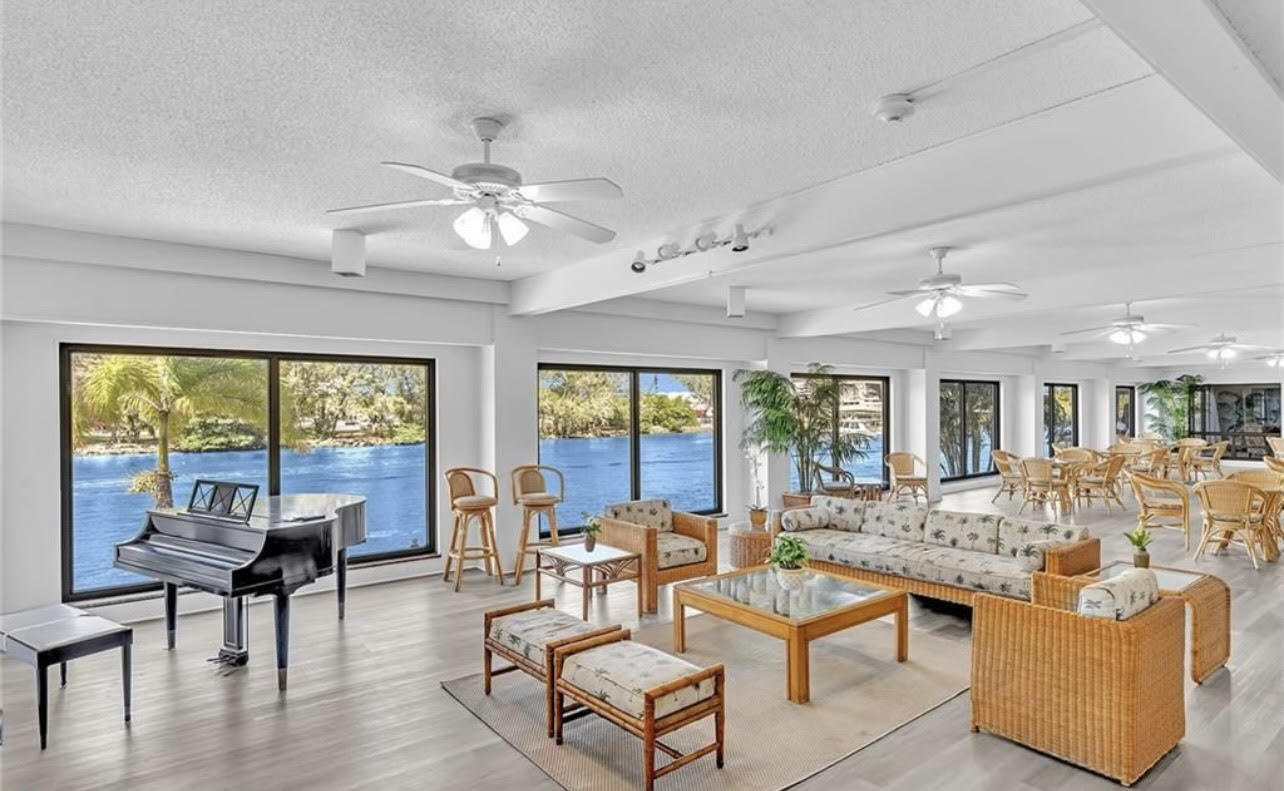 1401 North Riverside Drive, Unit 1205 Pompano Beach, FL 33062 - Photo 5 of 26 a living room with furniture dining table and a large window