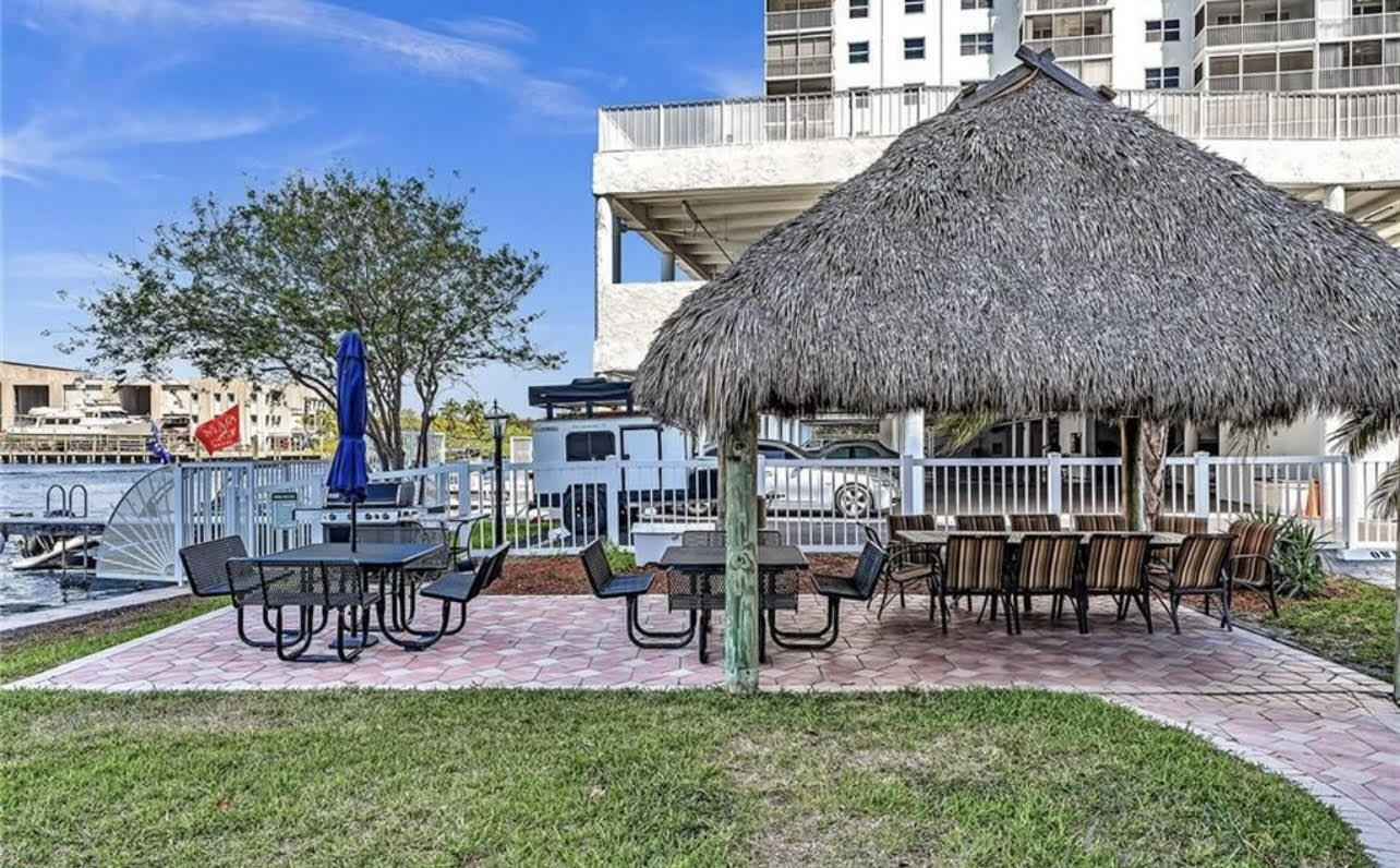 1401 North Riverside Drive, Unit 1205 Pompano Beach, FL 33062 - Photo 9 of 26 a view of a chairs and table in patio