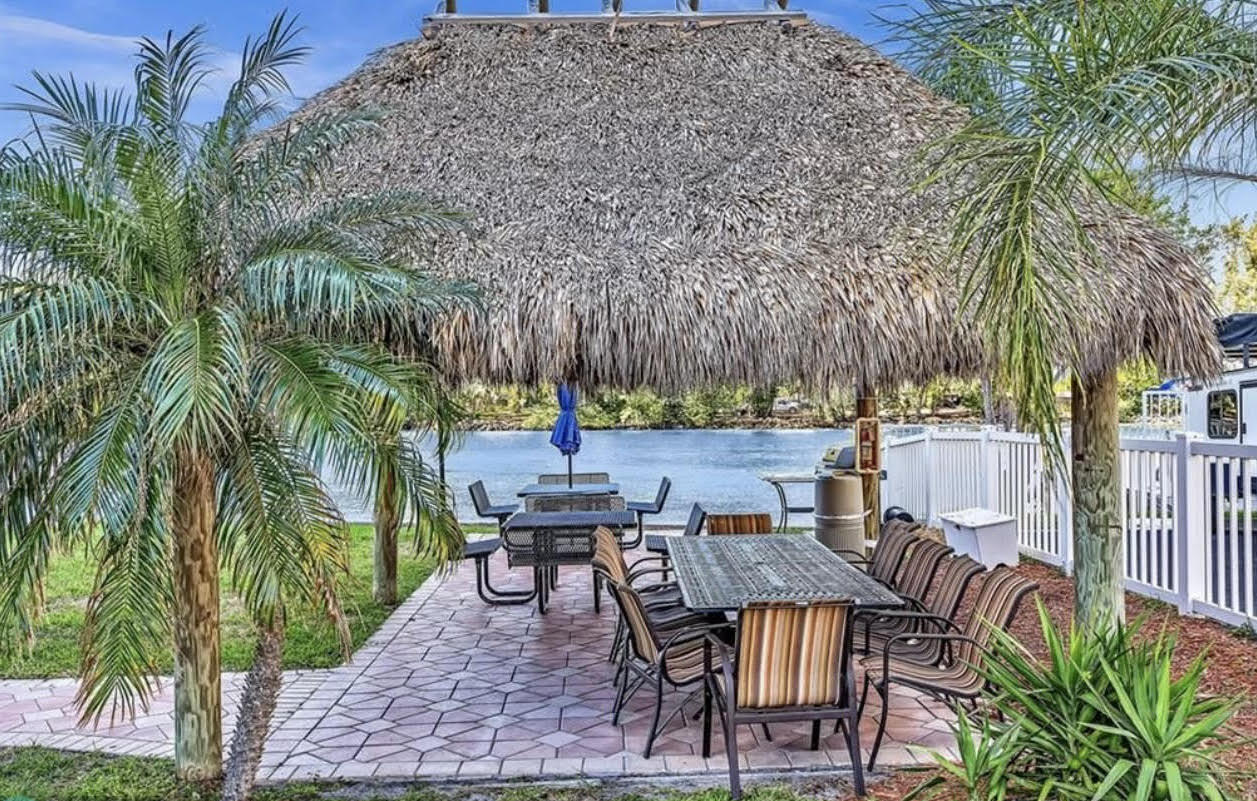 1401 North Riverside Drive, Unit 1205 Pompano Beach, FL 33062 - Photo 10 of 26 a backyard of a house with table and chairs