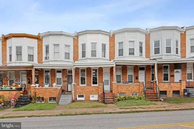 a view of a brick building next to a yard
